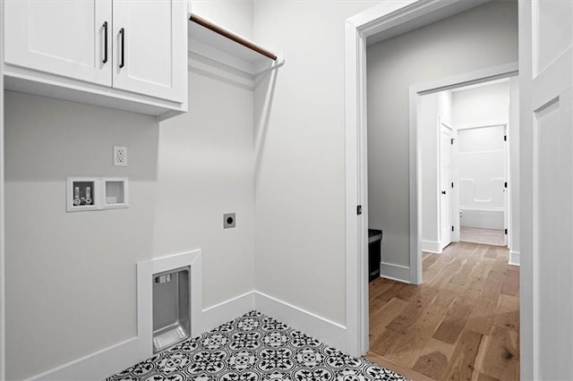 laundry area with washer hookup, electric dryer hookup, and cabinets