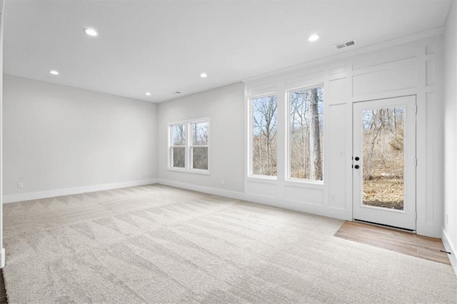 carpeted spare room featuring ornamental molding