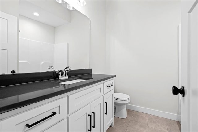 bathroom with toilet, a shower, vanity, and tile patterned floors