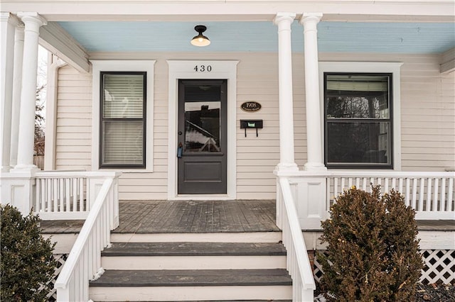 view of exterior entry with a porch