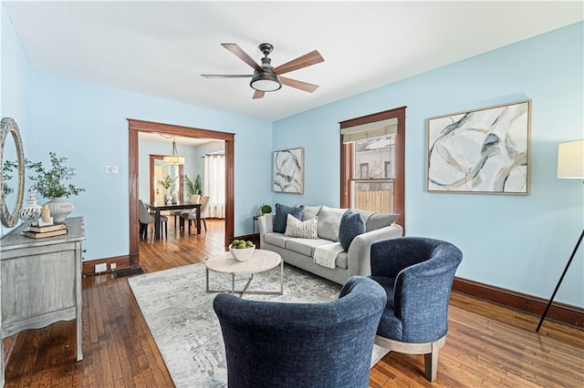 living room featuring hardwood / wood-style flooring and ceiling fan