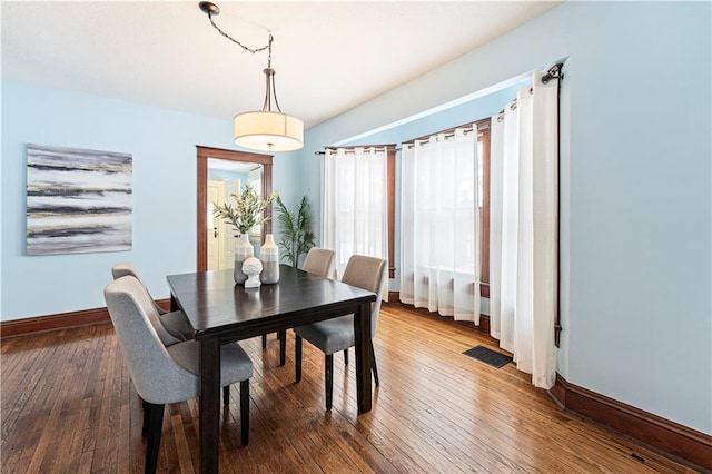 dining area with dark hardwood / wood-style flooring