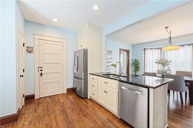 kitchen with white cabinetry, appliances with stainless steel finishes, sink, and kitchen peninsula