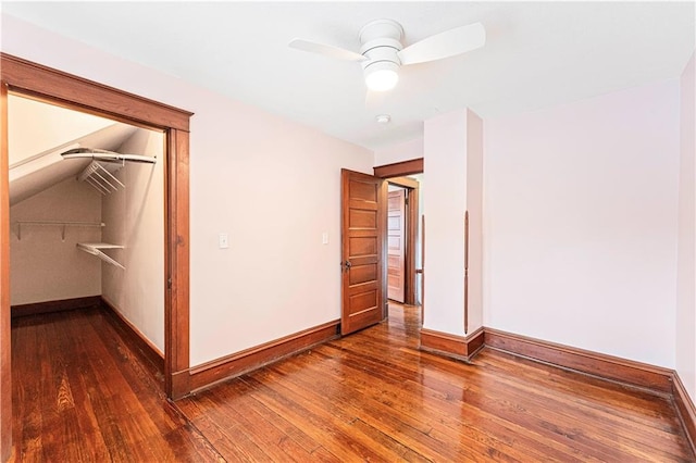 unfurnished bedroom featuring ceiling fan, dark wood-type flooring, and a closet