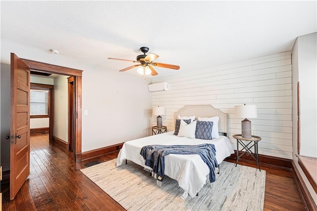 bedroom featuring a wall mounted air conditioner, ceiling fan, and dark hardwood / wood-style flooring