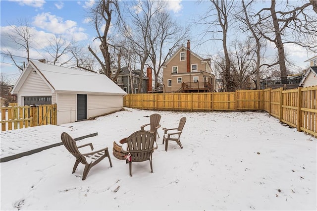 snowy yard with an outdoor fire pit