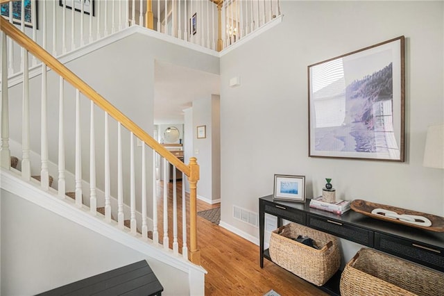 interior space with hardwood / wood-style flooring and a high ceiling