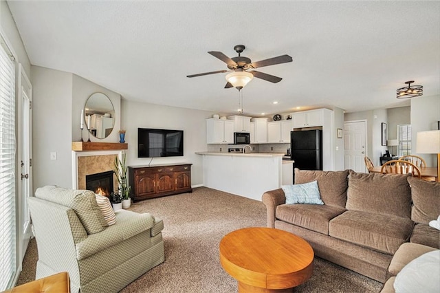 living room with light carpet and ceiling fan