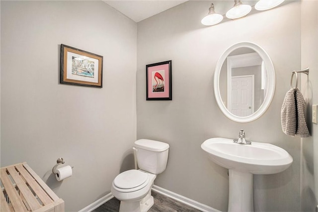 bathroom featuring wood-type flooring and toilet