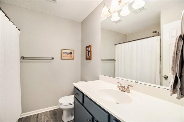 bathroom featuring vanity, hardwood / wood-style flooring, and toilet