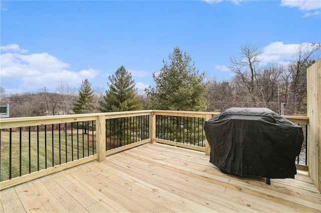 wooden deck featuring a yard and grilling area