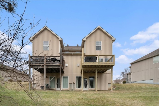 rear view of property with a wooden deck and a yard