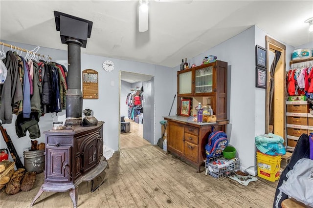 interior space featuring light wood-type flooring and a wood stove