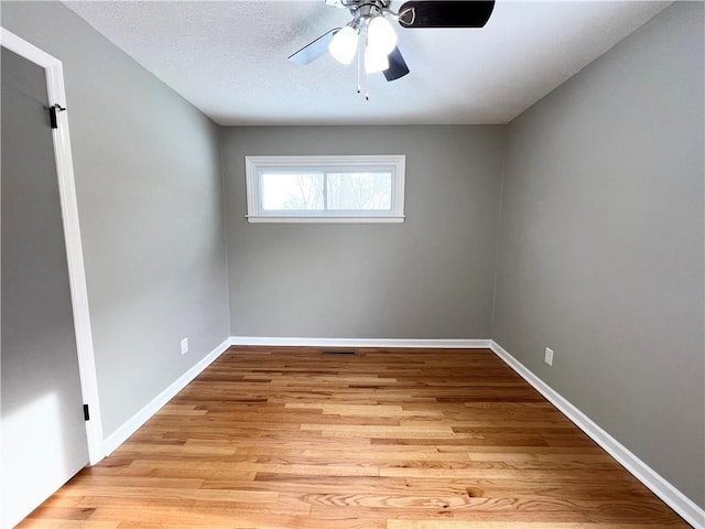 unfurnished room with ceiling fan, light hardwood / wood-style floors, and a textured ceiling