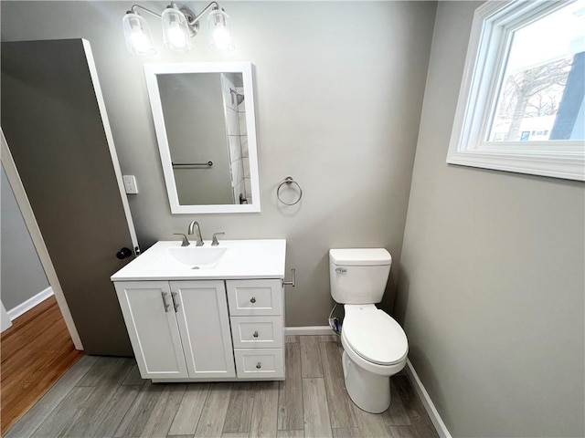 bathroom featuring vanity, toilet, and wood-type flooring