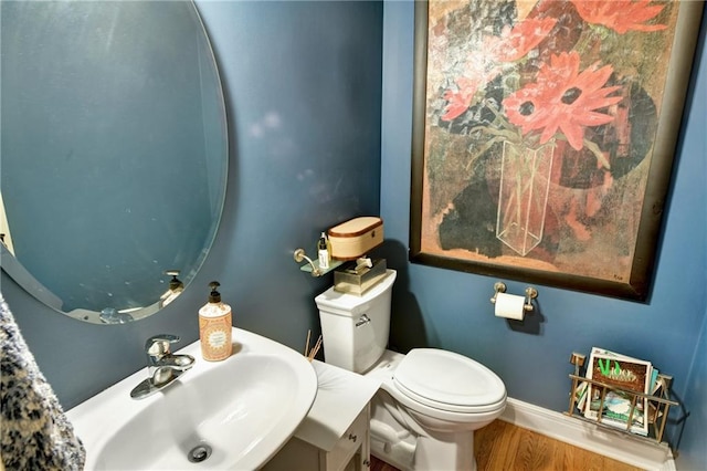 bathroom featuring sink, hardwood / wood-style floors, and toilet