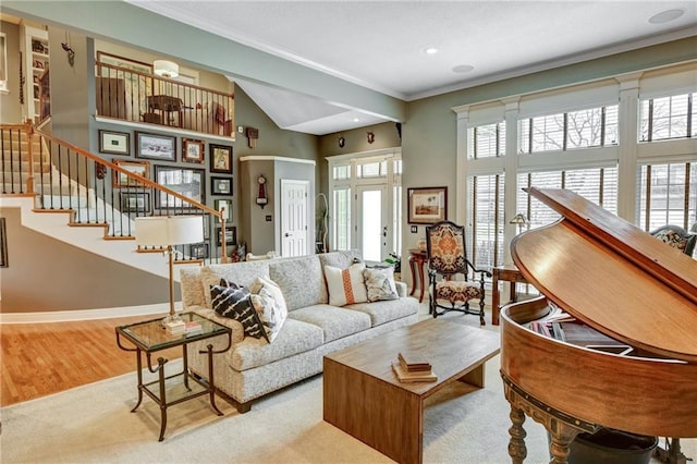 living room with crown molding, a wealth of natural light, and light wood-type flooring