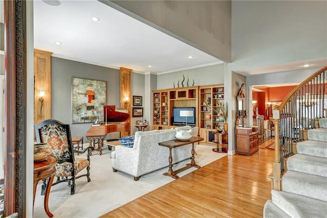 living room featuring light hardwood / wood-style flooring and ornamental molding