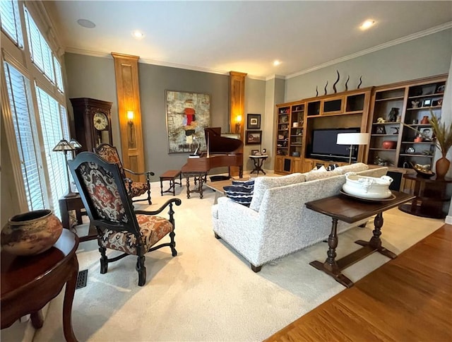 carpeted living room featuring ornate columns and crown molding