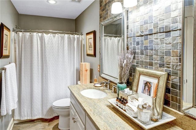 bathroom with vanity, walk in shower, a fireplace, and toilet