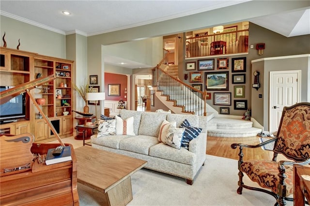 living room with crown molding and hardwood / wood-style flooring