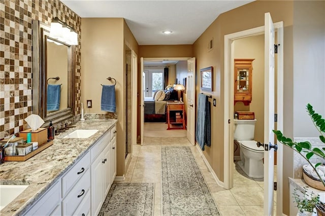 bathroom featuring vanity, tile patterned floors, and toilet