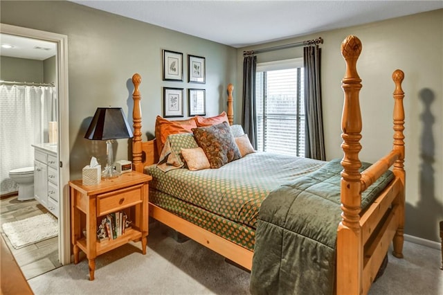 bedroom with carpet floors and ensuite bathroom