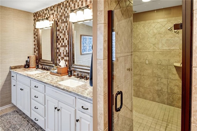 bathroom with walk in shower, tile patterned floors, vanity, and tile walls