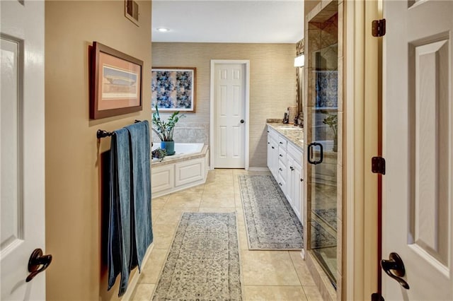 bathroom featuring vanity, tile patterned flooring, and plus walk in shower