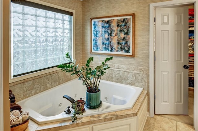 bathroom featuring tile patterned flooring and tiled tub