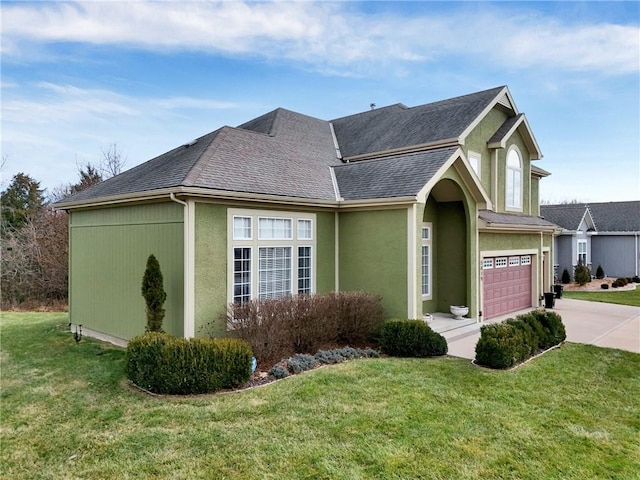 view of front of property with a garage and a front lawn