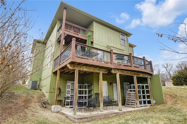 back of house featuring a wooden deck, a patio area, and central air condition unit