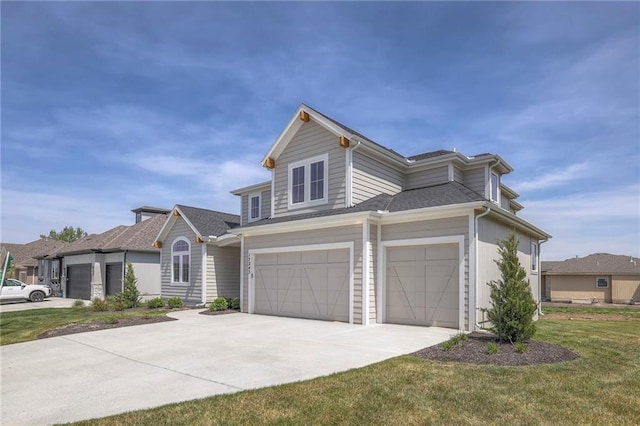 view of front of property with a garage and a front lawn