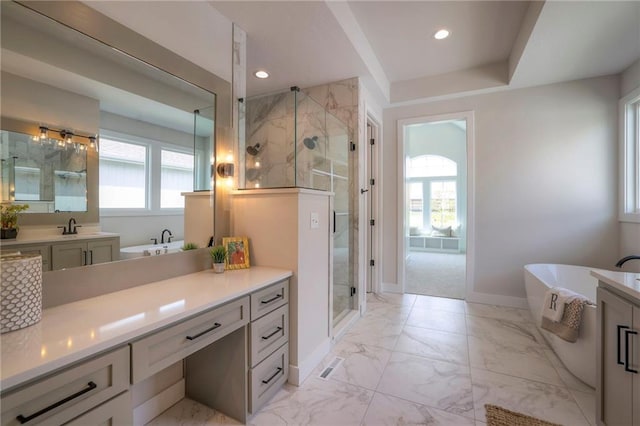 bathroom featuring vanity, a healthy amount of sunlight, and independent shower and bath