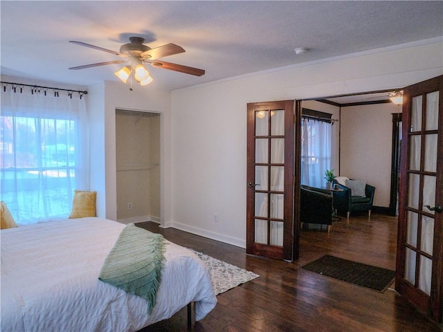 bedroom featuring ceiling fan, french doors, dark hardwood / wood-style flooring, and crown molding