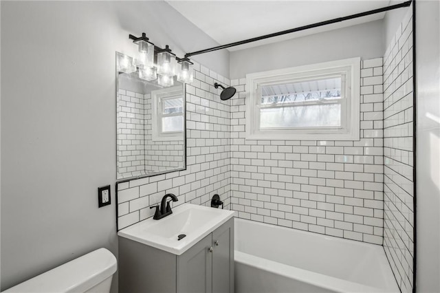 full bathroom featuring decorative backsplash, toilet, vanity, and tiled shower / bath combo