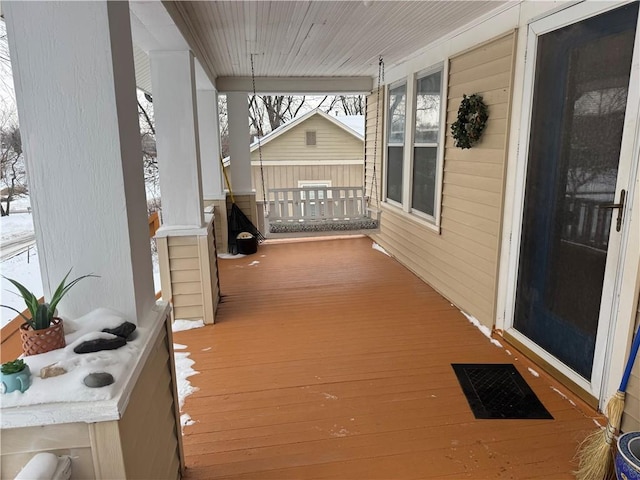 snow covered deck with covered porch