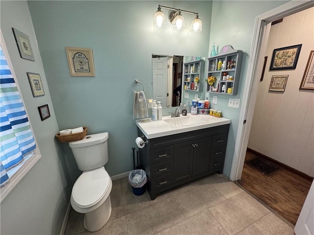 bathroom with tile patterned floors, vanity, and toilet