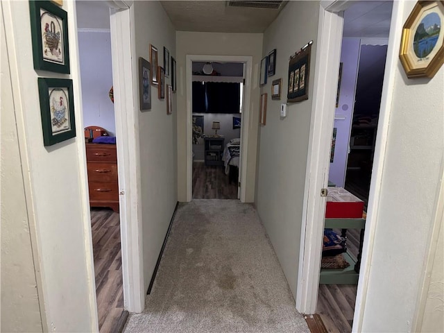 hallway with light colored carpet