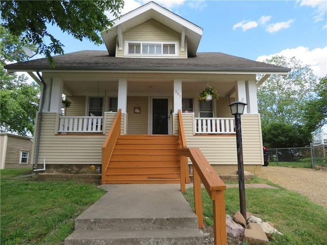 bungalow-style house with covered porch and a front yard