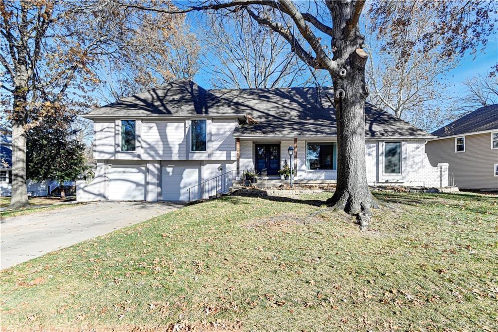 view of front of house with a garage and a front lawn