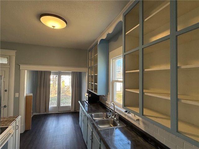 kitchen with built in shelves, range with electric cooktop, sink, and dark wood-type flooring