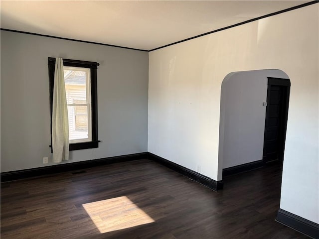 unfurnished room with dark hardwood / wood-style flooring