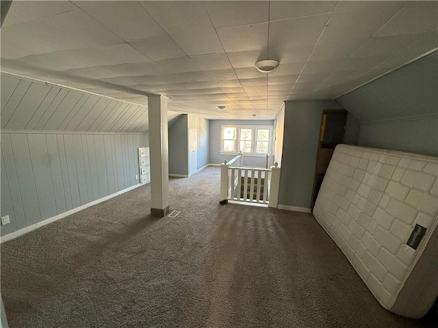 bonus room with carpet flooring and vaulted ceiling