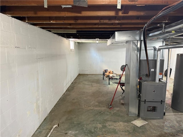 basement featuring heating unit and water heater