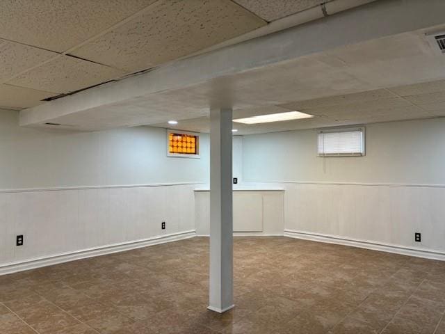 basement featuring a drop ceiling