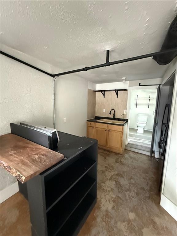 211 N Mulberry St, Maryville, MO 64468 - kitchen with dark countertops, open shelves, a textured ceiling, and light brown cabinetry