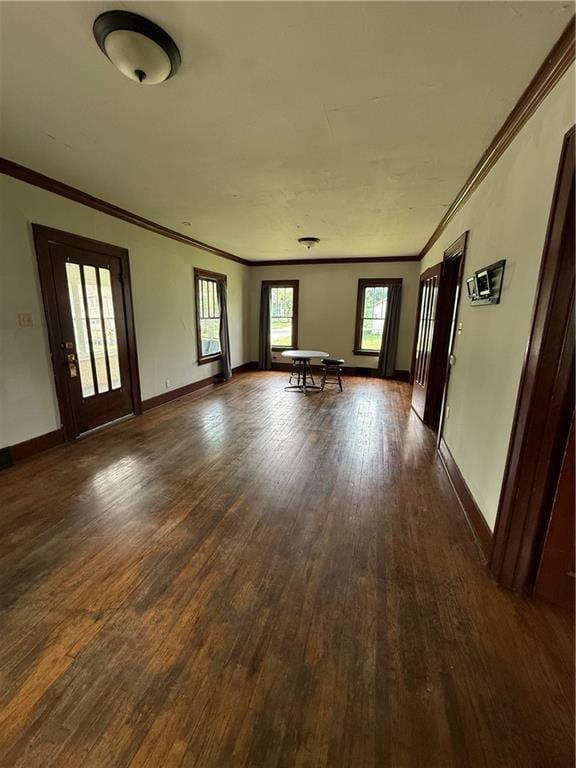 211 N Mulberry St, Maryville, MO 64468 - unfurnished living room featuring dark wood-style floors and ornamental molding