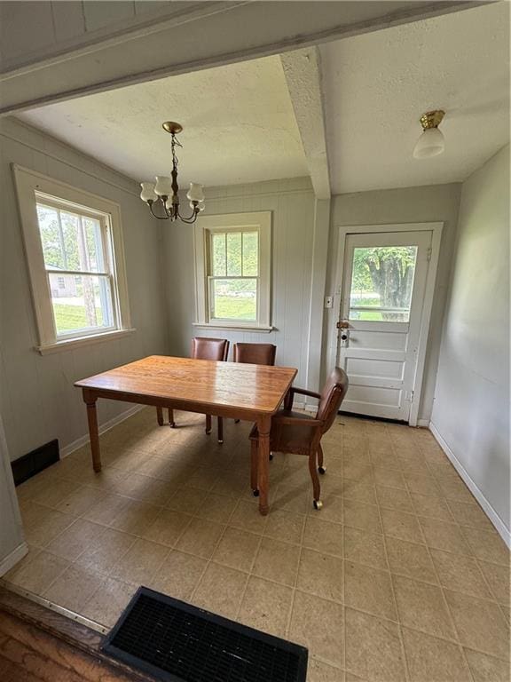 211 N Mulberry St, Maryville, MO 64468 - dining area featuring healthy amount of natural light, a chandelier, and a textured ceiling