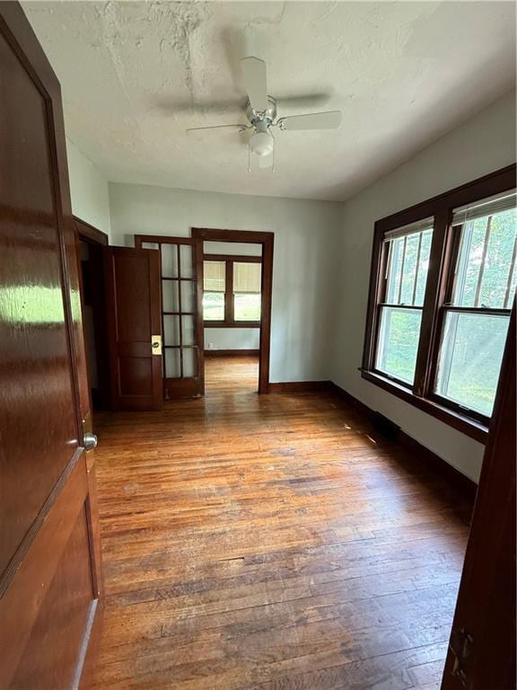211 N Mulberry St, Maryville, MO 64468 - unfurnished room with plenty of natural light, wood finished floors, and a ceiling fan